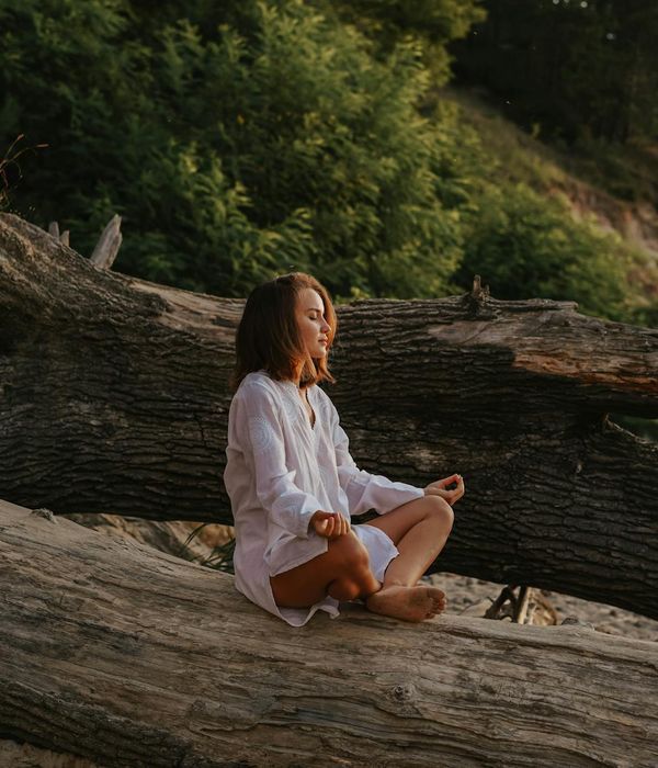 Woman practicing deep breathing in a calm night setting